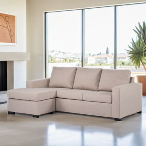 Een moderne woonkamer met een beige hoekbank met een daaraan vast een chaise longue. De kamer heeft een groot raam met uitzicht op een woonwijk, een potplant en een ingelijst abstract kunstwerk aan de muur.