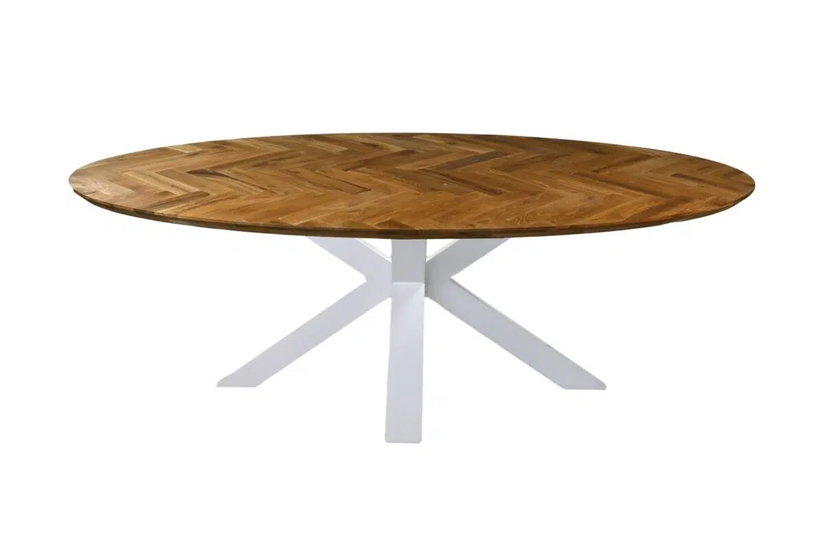 Een ronde houten tafel met een visgraatmotief op het bovenblad en een wit, modern kruispootonderstel. Het tafelblad heeft een warme, natuurlijke afwerking, die contrasteert met het strakke, moderne onderstel.