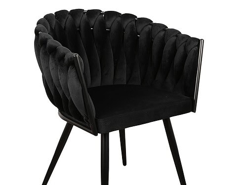 Een zwarte fluwelen stoel met een ingewikkeld gecapitonneerde rugleuning en strakke, hoekige poten. Het ontwerp is modern en elegant, met de nadruk op een luxe, comfortabele uitstraling.