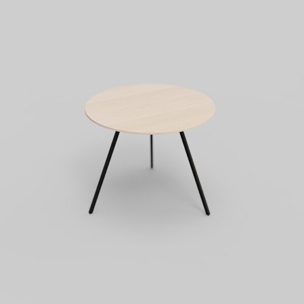 Een kleine, ronde houten tafel met een lichtgekleurd blad en drie zwarte metalen poten staat op een effen grijze achtergrond.