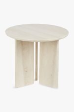 Een kleine, ronde, lichtbeige stenen tafel met een glad oppervlak. Het heeft een eigentijds ontwerp met drie platte, rechthoekige poten die in een driehoekige formatie zijn geplaatst en het tafelblad ondersteunen. De setting is tegen een effen witte achtergrond.