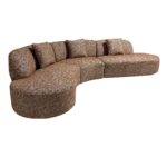 Een bruine, gebogen sectionele bank met een modern design en een gespikkeld patroon. Het heeft meerdere kussens langs de rugleuning en de vorm doet denken aan een zachte golf, wat zorgt voor voldoende zitruimte.