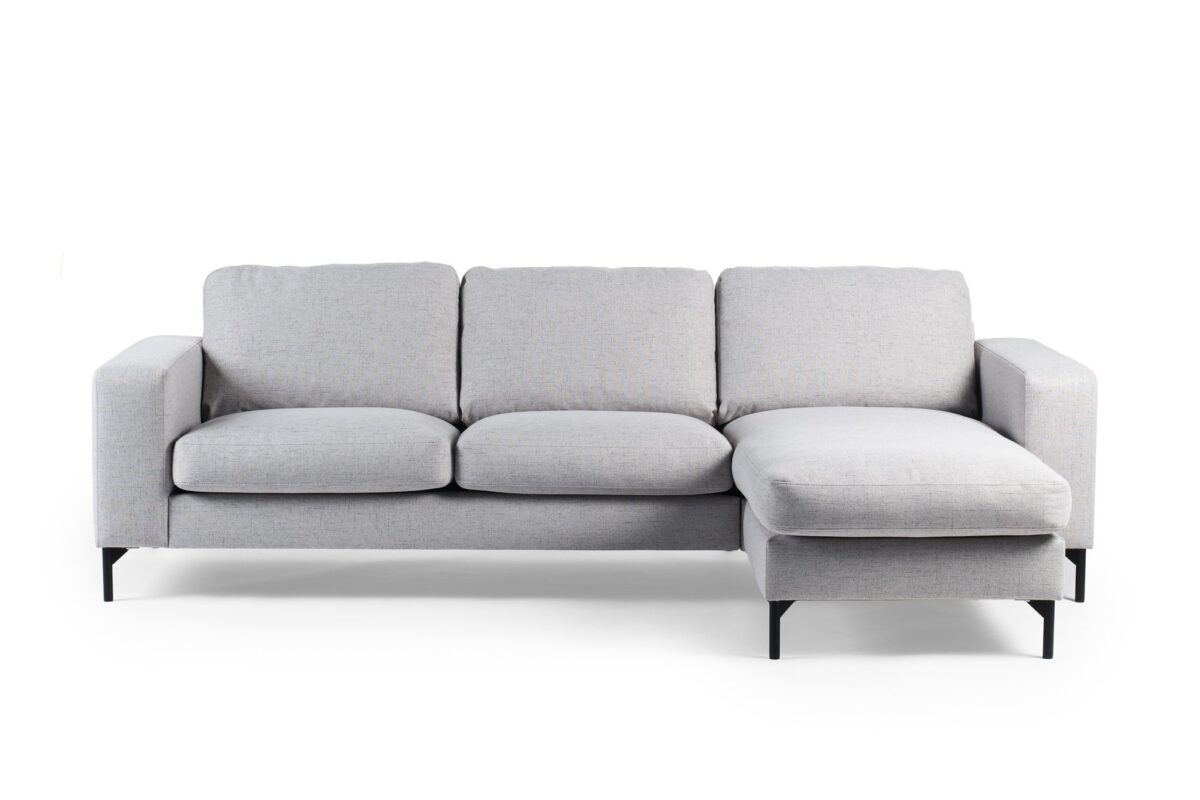 De 3 zits bank CL L+R in Valente V311 grijs stof heeft een modern lichtgrijs ontwerp met drie zitkussens, drie rugkussens en een chaise lounge aan de rechterkant, tegen een witte achtergrond.
