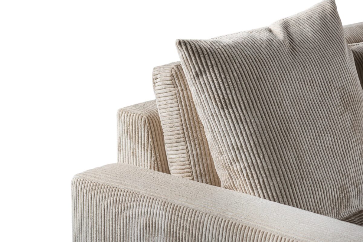 Close-up van de 3 zits bank CL L+R, stof Lincoln 83 in RIB920 naturel met gestructureerde beige corduroy stof en twee grote bijpassende kussens, tegen een witte achtergrond.