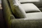 Close-up van de 3 zits bank CL L+R in Savannah stof, kleur S156 groen, met de groene suède-look bekleding, gladde armleuning en zacht rugkussen voor een comfortabele, moderne uitstraling.