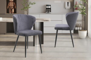 Twee Stoel 'Tornado' Corduroy Fabb Hyper 16 Grijs stoelen (set van 2) met metalen poten staan in een keuken of eetkamer met lichtkasten, een koffiezetapparaat, potplanten en decoratieve accenten op de achtergrond.