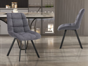 Twee 'Lizzy' eetkamerstoelen in donkergrijze stof (set van 2) met zwarte metalen poten staan op een glanzende marmeren vloer in een moderne keuken met een marmeren tafel en een minimalistische inrichting.