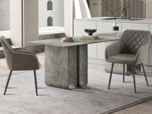 Een moderne keuken met een grijze stenen eettafel, twee Stoel 'Peron' Micro fiber PU Grijs stoelen, een licht vloerkleed, minimalistische inrichting en ingebouwde keukenkasten op de achtergrond.