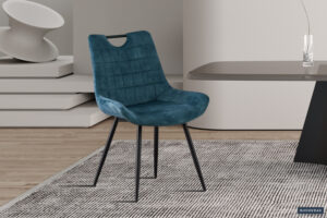 De Eetkamerstoel 'Alice' Bouclé Grijs (2 per doos) staat op een vloerkleed met grijze structuur naast een strakke tafel in een minimalistische kamer met lichte houten vloeren en geometrisch decor.