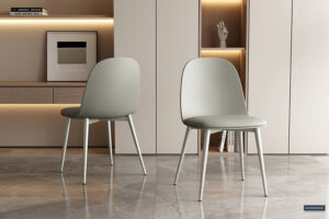 Twee Stoel 'Jasmin' stoelen met grijsgroene PP zittingen en PU kussens (2 per doos) staan op een gepolijste vloer in een stijlvolle kamer met neutrale kasten, open planken en een moderne inrichting.