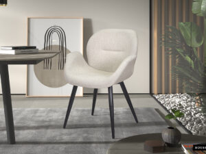 De Stoel 'Sevilla' Corduroy Fabb Hyper 16 Grijs (2 per doos) heeft een modern grijs gestoffeerd ontwerp met zwarte poten, geplaatst op een grijs vloerkleed in een minimalistische kamer die wordt geaccentueerd door abstracte kunst, een tafel, potplanten en decoratieve stenen.