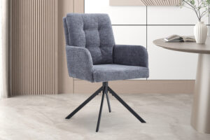 De Stoel 'Granada' Draaibaar tot 0 Stof Davis Bliss 75-73 Donkergrijs, met getufte rugleuning en zwart metalen poten, staat op een licht marmeren vloer bij een ronde tafel in een eigentijdse minimalistische kamer. (2 per doos).