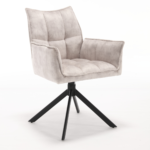 De Eetkamerstoel Dani | Velvet Champagne (set van 2) heeft een moderne lichtgrijze fluwelen bekleding, een gewatteerde zitting en rugleuning en zwarte metalen poten in een schuin vierpootsonderstel, afgezet tegen een effen witte achtergrond.