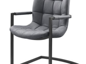 De Eetkamerstoel Savannah zwart - Stof Soft Antraciet is een moderne stoel met een gewatteerde, antracietgrijze zitting en rugleuning met vierkante knopen, zwarte metalen armleuningen en een vrijdragend geometrisch metalen frame.