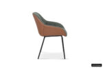 Zijaanzicht van de SALE - Stoel 'Sem' Stof Groen Rug PU Cognac, met een groene stoffen zitting, cognac PU leren rugleuning en slanke zwarte metalen poten tegen een witte achtergrond. Rousseau branding is zichtbaar in de rechter benedenhoek.