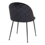 De Geneve Eetkamerstoel is een moderne eetkamerstoel van zwart fluweel met slanke zwarte metalen poten, van achteren schuin afgebeeld op een witte achtergrond. Set van 2.