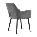 De Eetkamerstoel Ray - Antraciet is een moderne fauteuil met gestructureerde grijze bekleding en vier licht schuin geplaatste zwarte poten, van achteren gezien in een lichte hoek.