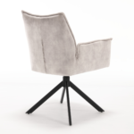 De Eetkamerstoel Dani | Velvet Champagne (set van 2) heeft een moderne fluwelen bekleding, een hoge rug, armleuningen en een slanke zwart metalen vierpotige draaivoet, afgebeeld tegen een witte achtergrond.