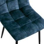 Een close-up van de Eetkamerstoel Yerevan Velvet Petrol, een donkerblauwe stoel met fluwelen bekleding, een gewatteerd kussen met vierkant patroon en zwarte metalen poten.