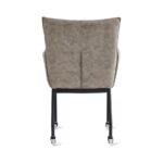 De Eetkamerstoel Thomas - Microleder Taupe heeft een gecapitonneerde taupe microleder rugleuning en zitting, zwart metalen poten met vier wieltjes, van achteren gezien tegen een witte achtergrond.