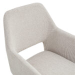 Close-up van de Eetkamerstoel Tess Linnen Beige, een moderne lichtbeige gestoffeerde stoel met een gebogen rugleuning, geïntegreerde armleuningen, een uitsparing tussen rugleuning en zitting en subtiel geweven stof met structuur.