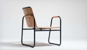 A sleek, modern buisframe chair with graceful armrests stands in a minimalist, well-lit studio setting. The chair's tubular steel frame is painted in a matte black finish, contrasting beautifully with the smooth, light-colored wooden seat and backrest. Subtle details, such as the gently curved armrests and the seamless connection between the frame and the seat, showcase the chair's thoughtful design. The lighting, positioned to accentuate the chair's clean lines and angles, casts a soft, even glow, creating a sense of elegance and sophistication. The overall composition emphasizes the chair's unique, functional aesthetic, inviting the viewer to appreciate its form and purpose.