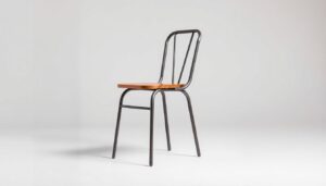 An industrial-style dining chair without armrests, standing alone in a well-lit studio setting. The chair features a sturdy metal frame with a weathered, distressed finish, creating an authentic, utilitarian aesthetic. The seat is made of a durable, high-quality wood material, potentially with a lightly textured surface. The entire composition is captured from a slightly elevated angle, showcasing the chair's clean lines and minimalist design. The background is simple and uncluttered, allowing the chair to be the focal point, with neutral tones that complement the industrial theme. The lighting is soft and diffused, creating gentle shadows that accentuate the chair's form and materiality, evoking a sense of timeless, functional elegance.