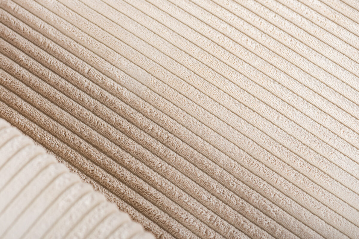 Close-up van 3 zits hoekbank rechts in Lincoln 03, RIB460 beige stof, met nadruk op de zachte corduroy textuur met parallelle ribbels en een geplooid gedeelte linksonder.