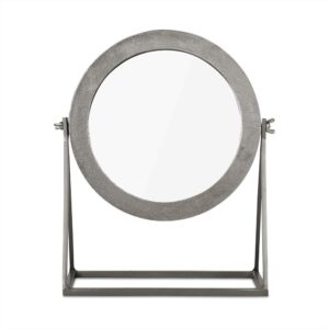 De Spiegel op Standaard Zilver is een ronde tafelbladspiegel met een metalen frame en standaard, voorzien van verstelbare zijschroeven om te kantelen.