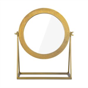De Spiegel op Standaard Goud is een ronde tafelbladspiegel met een gouden lijst en staander op een rechthoekige voet, voorzien van twee zijscharnieren waarmee je de spiegel rechtop kunt kantelen.