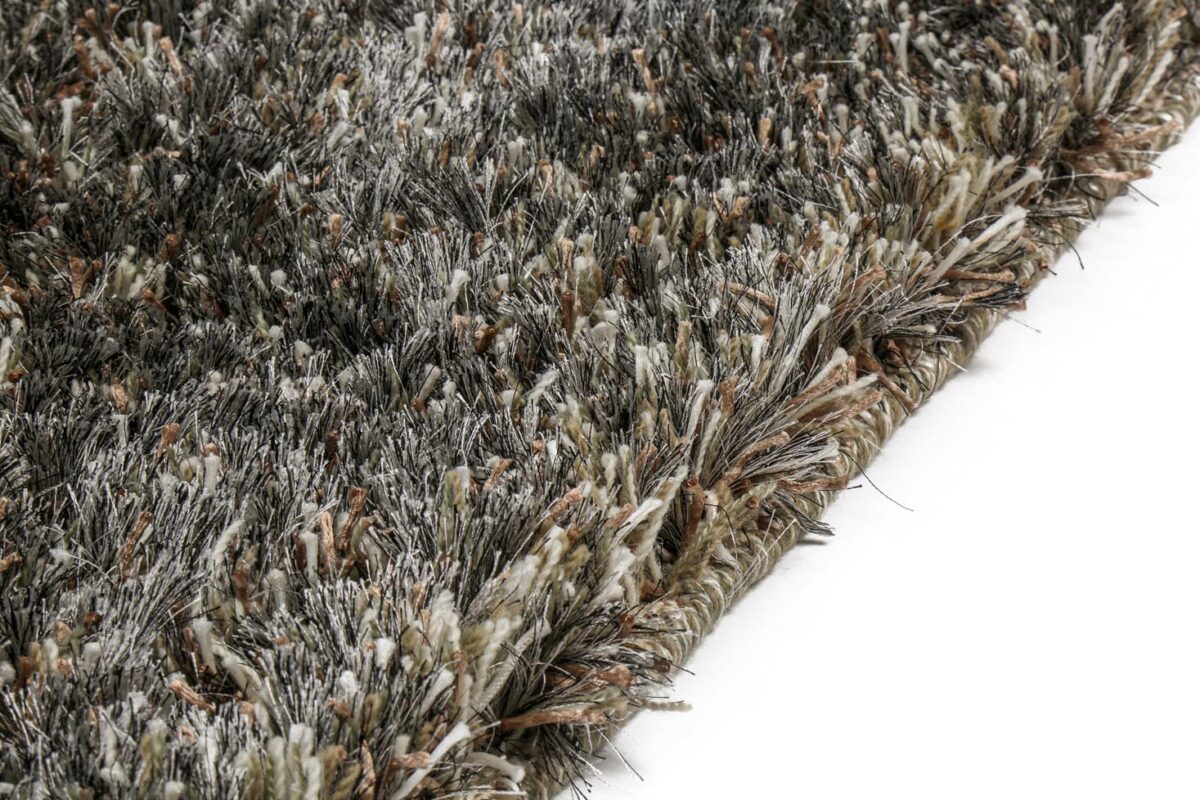 Close-up van de hoek van het New Paulo Grey mix 862 200x300 shaggy vloerkleed, met dikke veelkleurige vezels in grijs, bruin en beige op een wit oppervlak.