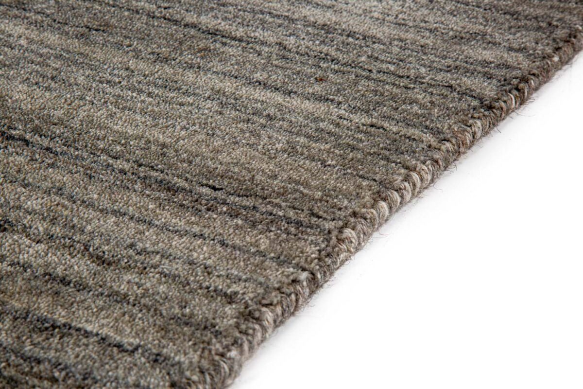 Close-up van het Portofino Grey 03 200x300 vloerkleed, met een gestructureerd, rechthoekig ontwerp met zacht geweven randen en subtiele donkere en lichte horizontale strepen, tegen een witte achtergrond.