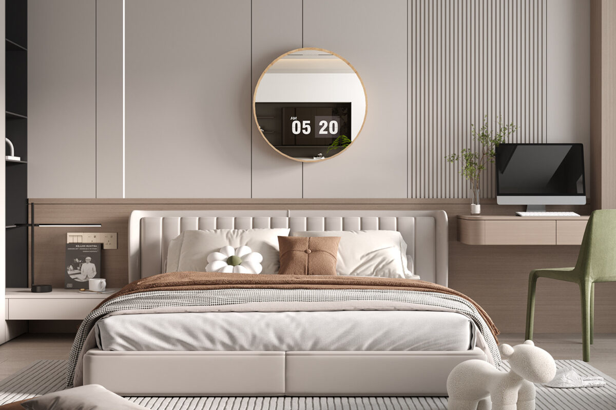Een moderne slaapkamer met de Spiegel 'Roxy' 80x80 Oude eik (1c) ronde spiegel boven een beige gestoffeerd bed, bruin en wit beddengoed, een aan de muur bevestigd bureau met een computer en een groene stoel.