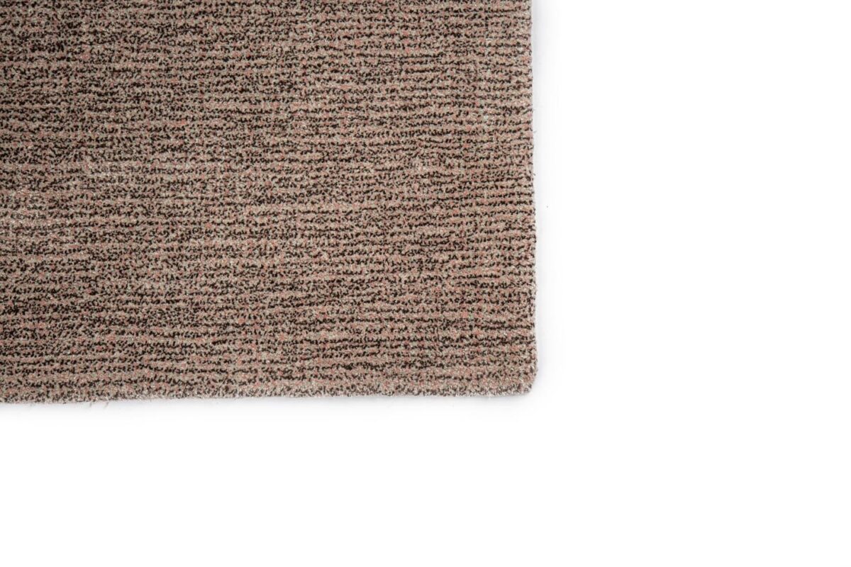 Een close-up van de hoek van het tapijt Rome Grey 03 170x230, met de textuur van geweven vezels in bruine en beige tinten tegen een witte achtergrond.