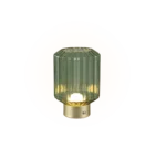 De REALITY Tafellamp LORD is een kleine tafellamp met een geribbelde cilindrische kap van groen glas en een goudmetalen voet die een warm licht uitstraalt.