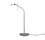 De TRIO Tafellamp Monza is een moderne metalen lamp met een ronde voet en een slanke gebogen hals die een platte ronde kop ondersteunt en zacht wit licht uitstraalt.