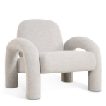 De Fauteuil Phiel - Bouclé Naturel is een moderne fauteuil met zachte, ronde vormen, dikke gebogen poten en armen en een minimalistisch eigentijds ontwerp, bekleed met natuurlijke boucléstof.