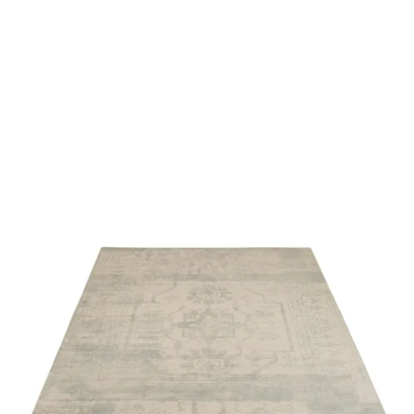 De Vloerkleed Jacquard Wol Beige/Blauw is een vierkant vloerkleed met lichtbeige en grijze tinten met een vervaagd, verweerd patroon op een effen witte ondergrond.