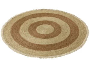 De Vloerkleed Kwastband Maïsschil/Katoen Beige/Bruin Wit is een rond geweven vloerkleed met concentrische beige en bruine ringen, een getextureerde afwerking en franje langs de buitenrand.