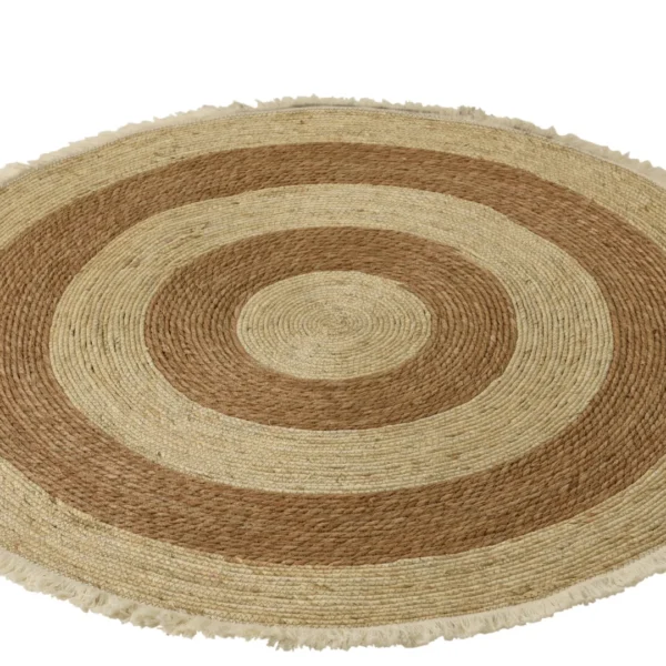 De Vloerkleed Kwastband Maïsschil/Katoen Beige/Bruin Wit is een rond geweven vloerkleed met concentrische beige en bruine ringen, een getextureerde afwerking en franje langs de buitenrand.