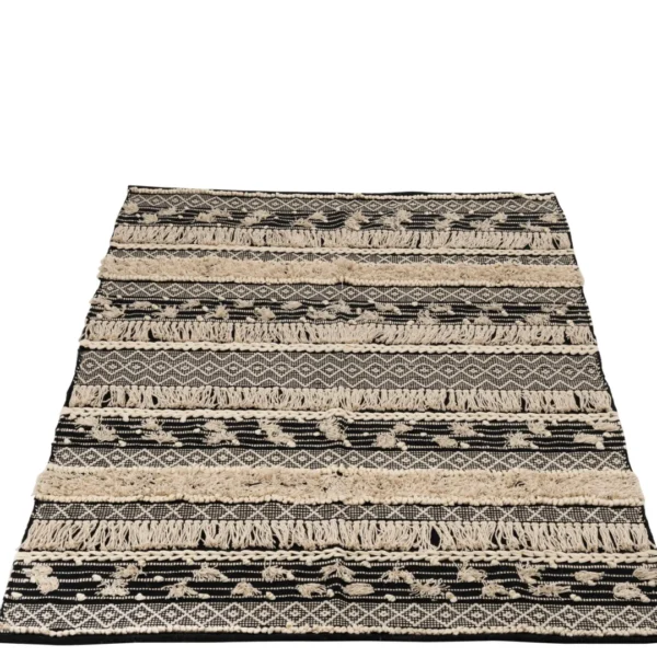 Vloerkleed Monochroom Katoen Zwart/Wit Groot is een rechthoekig vloerkleed met afwisselend zwarte en witte patronen met geometrische vormen, zigzagpatronen en verhoogde getufte delen op een witte achtergrond.