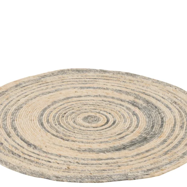 Het Vloerkleed Rond Maïs Beige/Blauw is een rond geweven tapijt met concentrische cirkelvormige patronen in beige en blauwe tinten, gemaakt van natuurlijke vezels en weergegeven op een witte achtergrond.