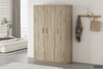 In een minimale, opgeruimde slaapkamer staat de Opbergkast 'Mike' 120 cm 3 deuren Sonoma (3c), een moderne houten kledingkast met drie deuren. Aan een wandhaak hangen een geruit overhemd en een hoed, terwijl op de achtergrond een bed zichtbaar is.