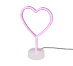 De REALITY Tafellamp HEART is een roze neon, hartvormige tafellamp op een witte ronde voet met een zwart netsnoer tegen een effen achtergrond.
