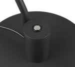 Close-up van de zwarte cilindrische voet van de TRIO Tafellamp Manduro, met een metalen knop bovenop en een aangesloten elektriciteitssnoer.