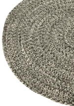 Een close-up van het Vloerkleed Miami Outdoor Poly Zwart/Wit Klein, een rond vloerkleed met een zwart-wit zigzagpatroon op een effen witte achtergrond.