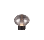 De REALITY Tafellamp EARL is een ronde, geribbelde glazen tafellamp met een metallic afwerking en een zwarte cilindrische voet, van binnenuit verlicht.