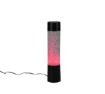 De REALITY Tafellamp GLITTER is een hoge, cilindervormige zwarte lamp met heldere zijkanten gevuld met fonkelende glitters en voorzien van gloeiend rood licht aan de onderkant; er loopt een elektriciteitssnoer vanaf de voet.