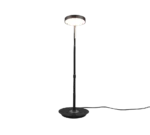 De TRIO Tafellamp Monza is een moderne zwarte vloerlamp met een ronde voet en ronde kap, afgebeeld op een effen witte achtergrond met het netsnoer aan de zijkant.