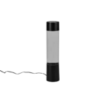 De REALITY Tafellamp GLITTER is een hoge, cilindervormige lamp in zwart en helder, met een netsnoer aan de linkerkant tegen een effen witte achtergrond.
